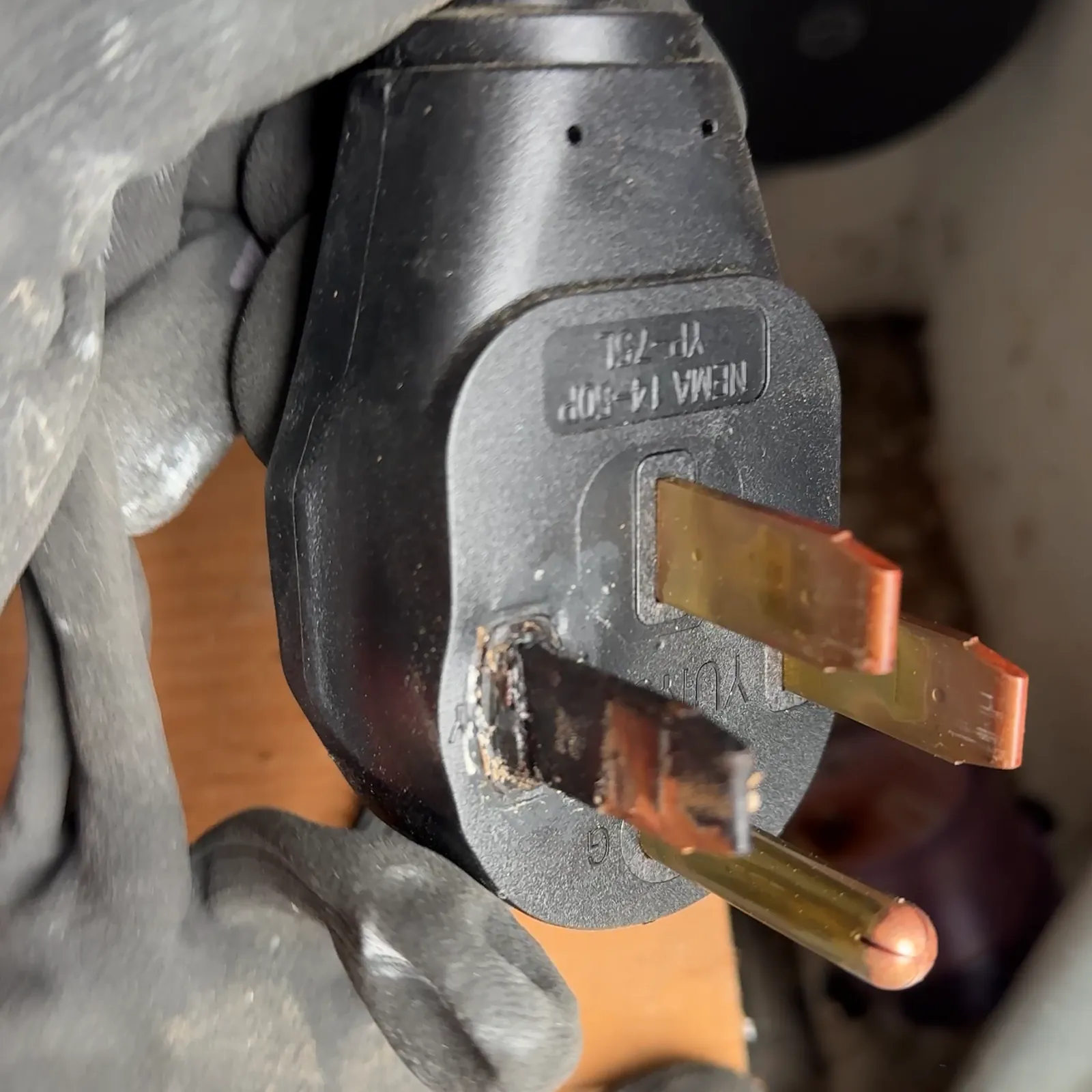 Burned blade on a NEMA 14-50 plug from an EV charging setup