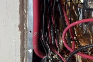 200-amp service conductor pressed against the side of an electrical panel in a San Jose home, with damaged insulation