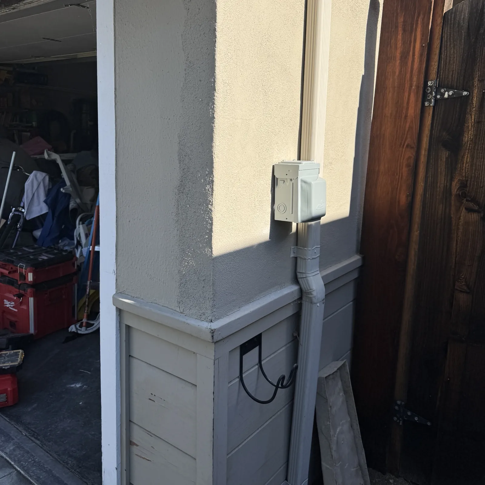 New NEMA 14-50 EV charger outlet in a weatherproof box on an exterior wall of a San Jose home
