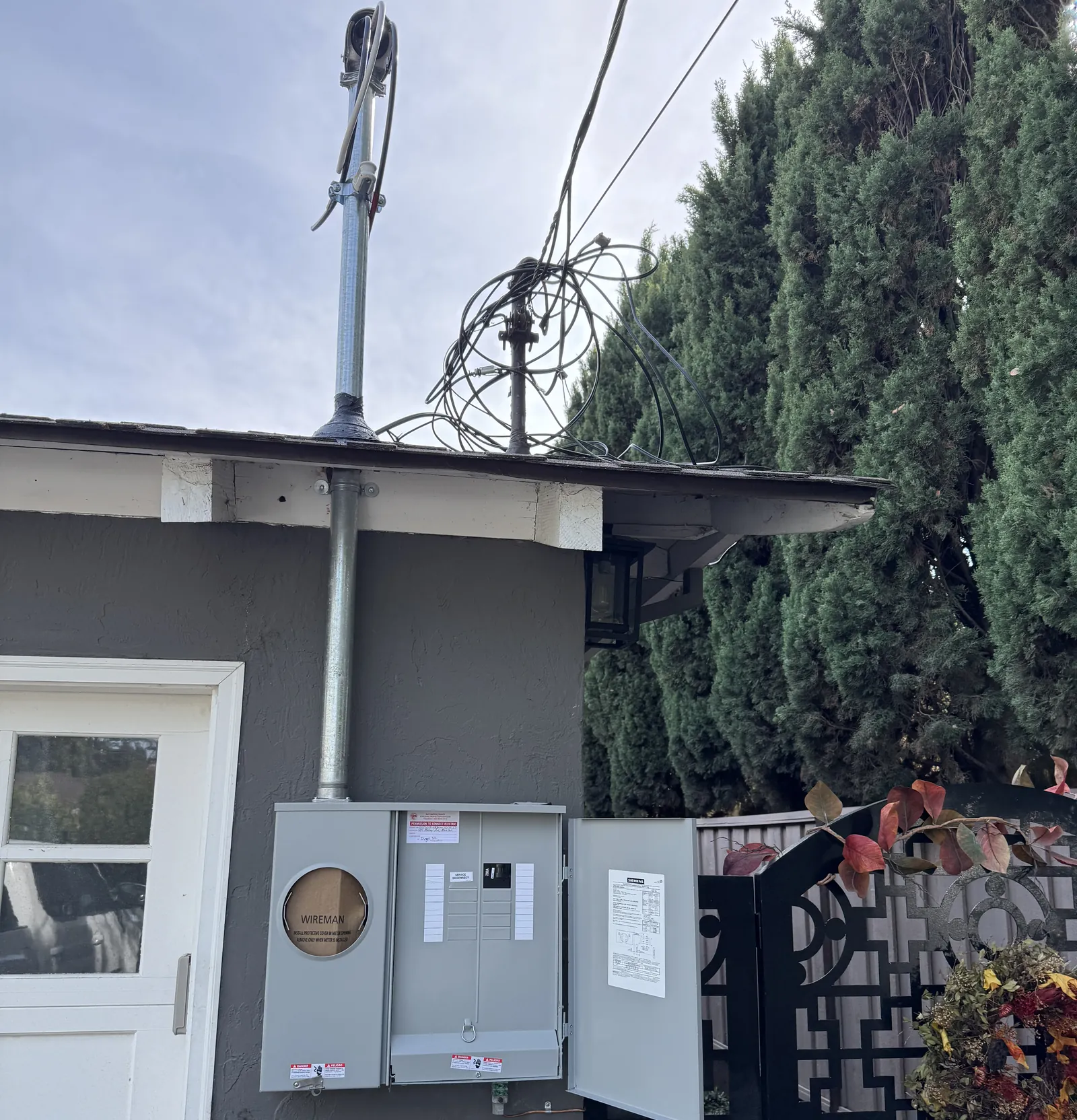New electrical service mast and meter main panel on a home, with the overhead service drop not yet connected