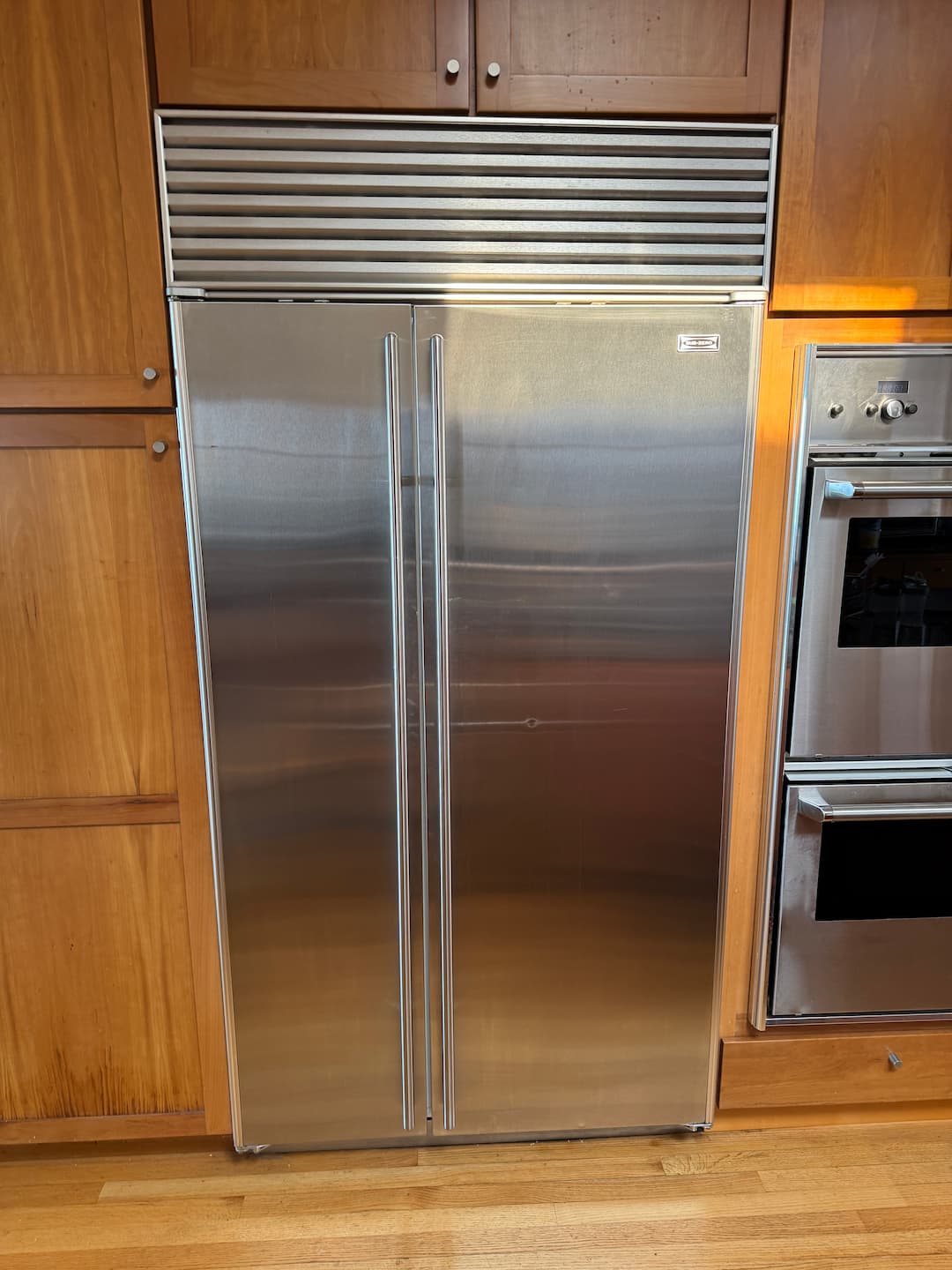 HAXX technician diagnosing refrigerator repair issue