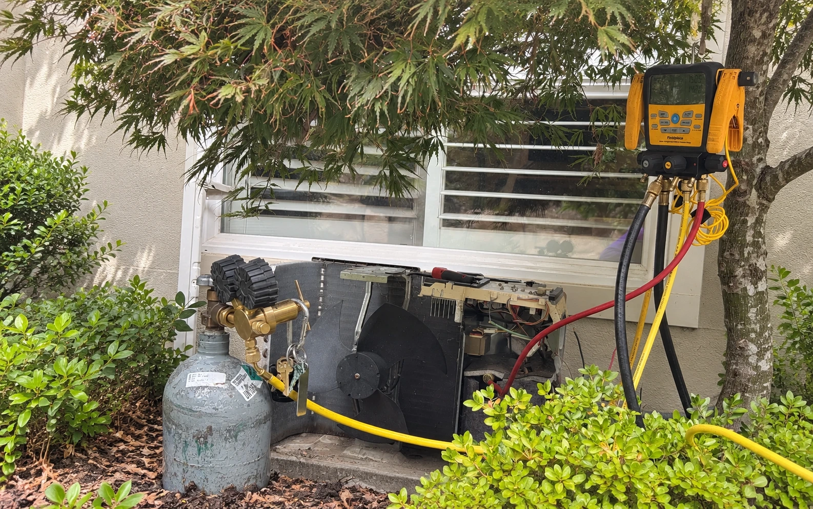 HAXX technician running leak detection on a Mitsubishi ductless heat pump