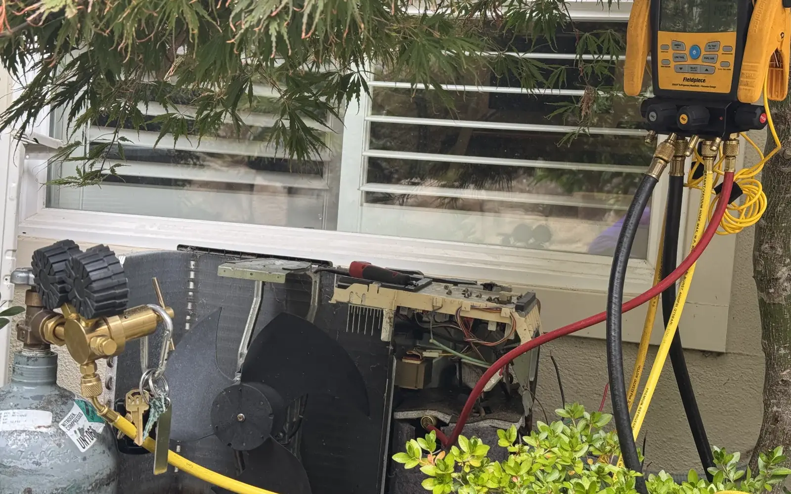 HAXX technician running leak detection on a Mitsubishi ductless heat pump